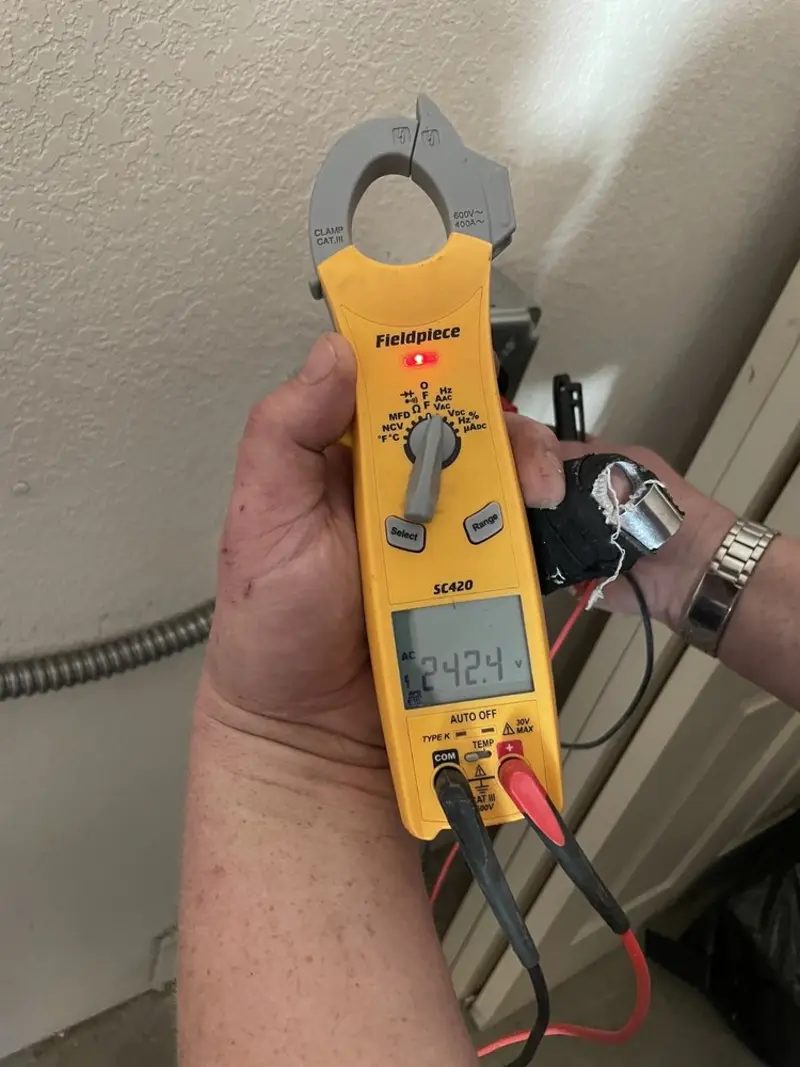 Voltage testing with clamp meter during Whole House Surge Protector in Pueblo